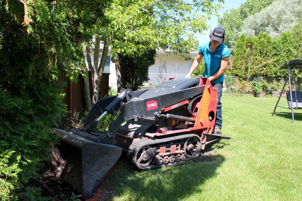 A cleanr employee working on a residential lawn