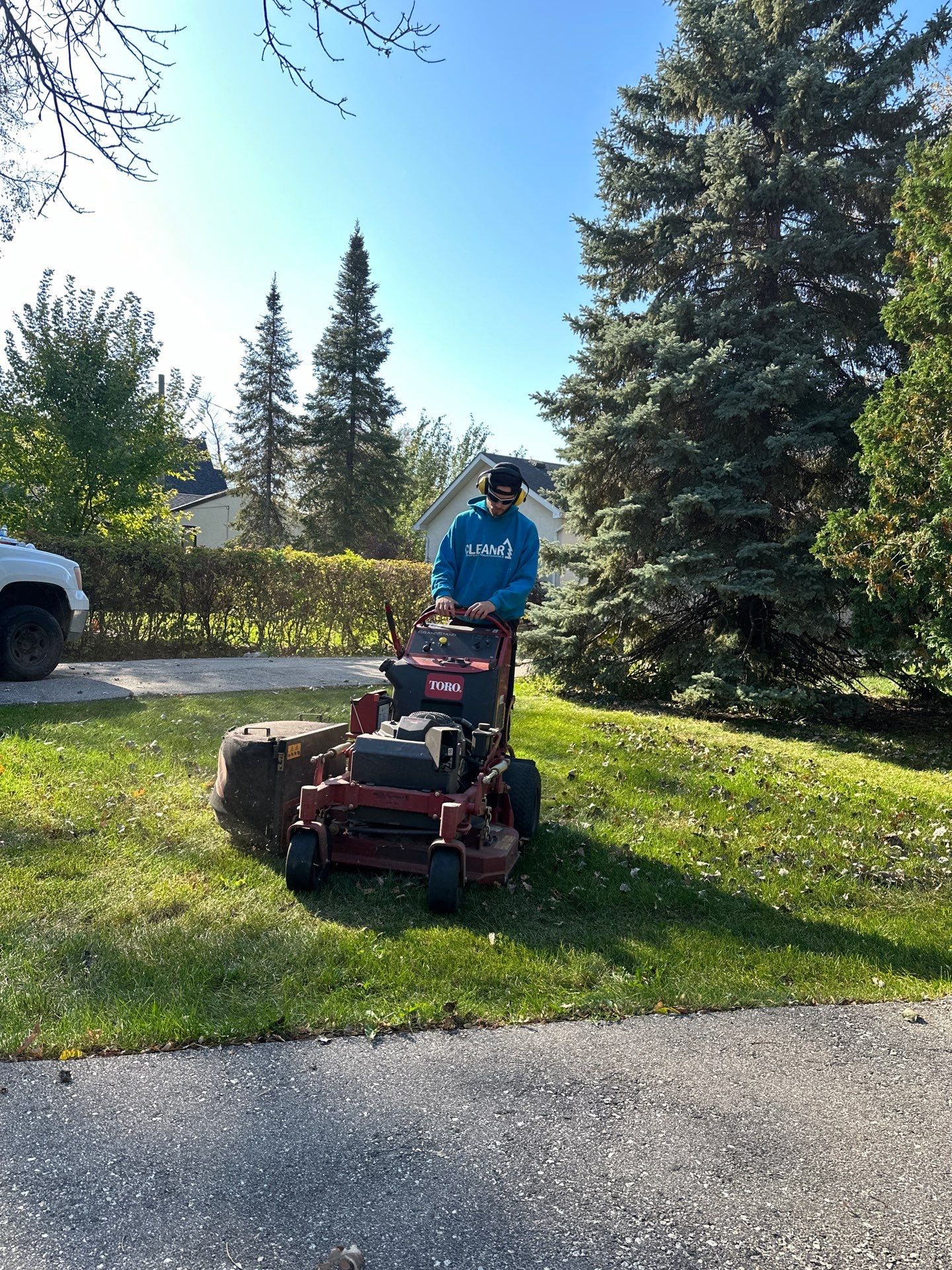 an employee of cleanr mowing a lawn